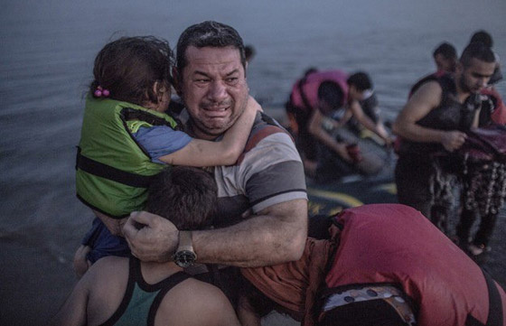 صورة لاجئ سوري يحتضن طفليه بعد عبورهم البحر تصدم العالم صورة رقم 1