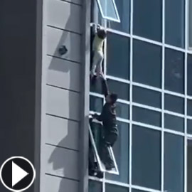 فيديو يحبس الأنفاس لطفلة تتدلى من الطابق الثامن.. ورجل يخاطر بحياته!